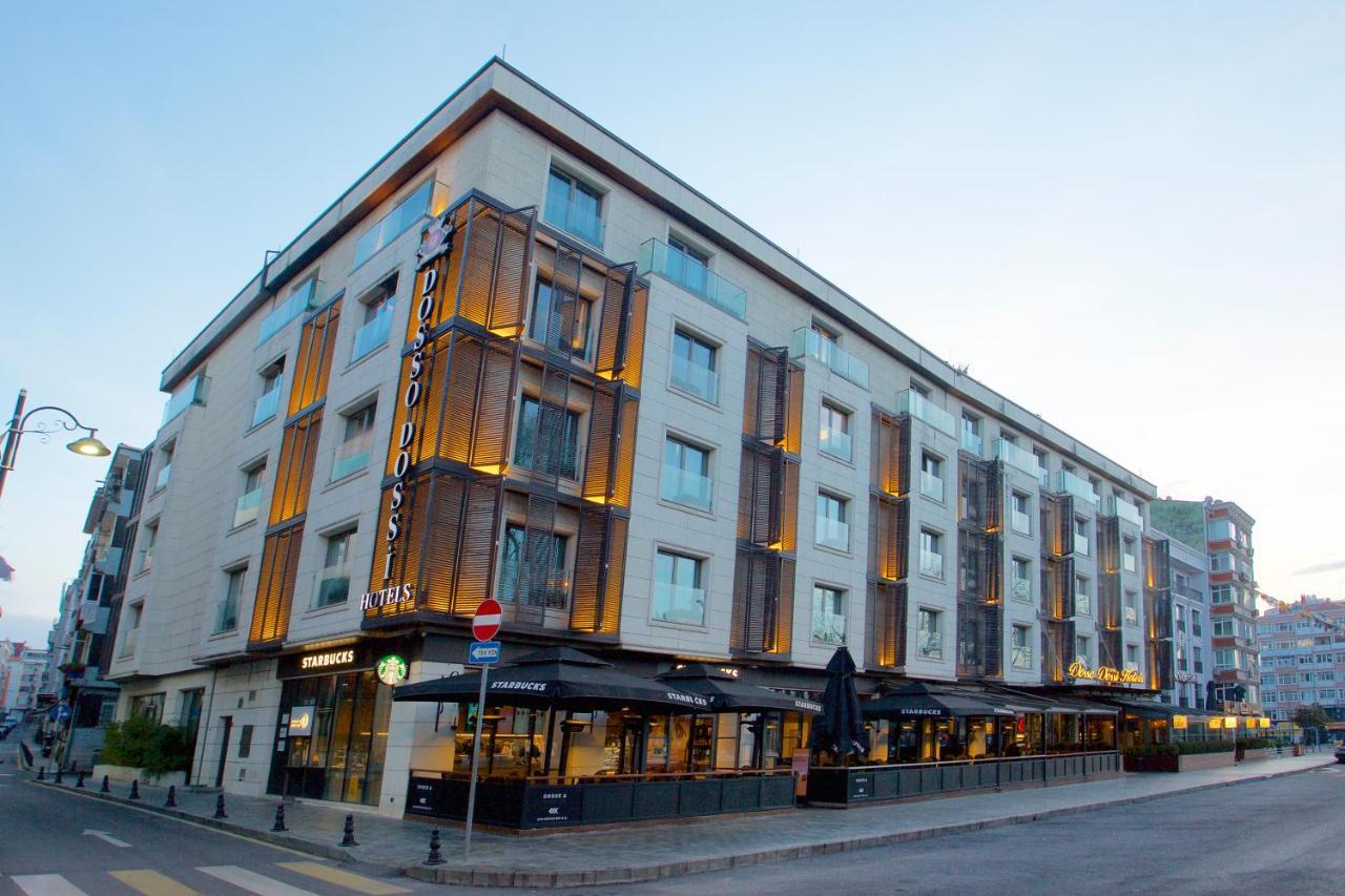 Dosso Dossi Hotels & Spa Downtown Istanbul Exterior photo The photo shows a modern building that appears to be a hotel. It has a contemporary architectural design with a mix of light-colored walls and wooden accents. The structure is four stories high and features large windows that allow for plenty of natu